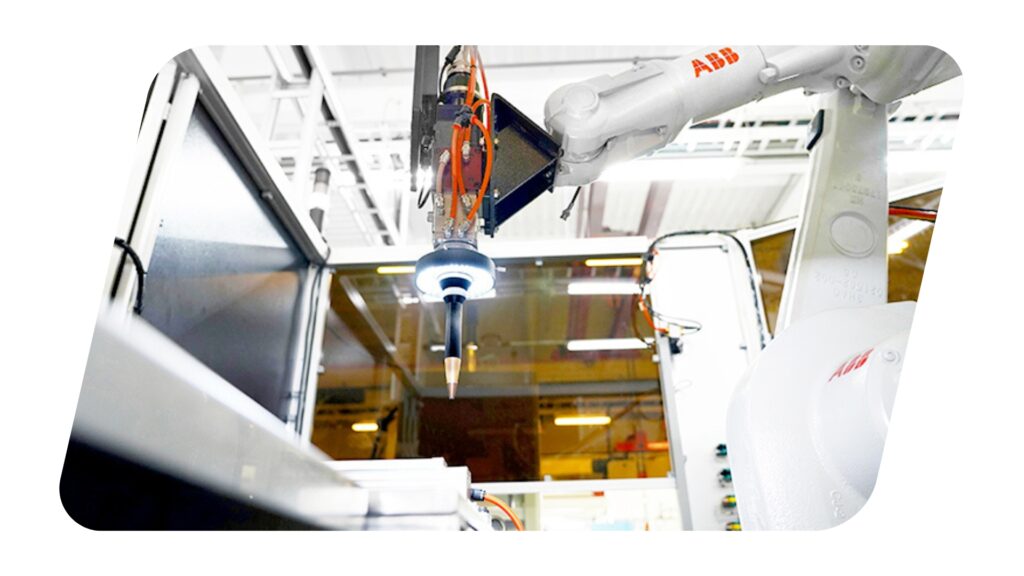 Picture of an industrial robot arm doing an automatic laser welding process.