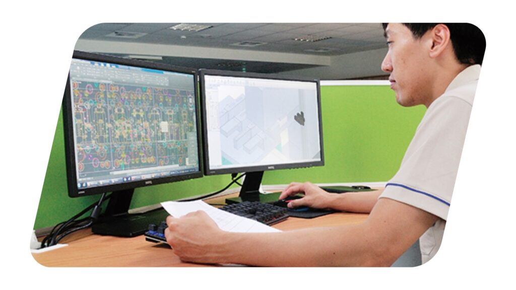 A picture of a Ladata engineer in front of a computer screen working in a CAD file.
